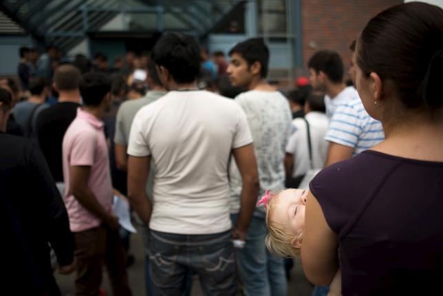 asylum seekers wait in front of the federal office for migration and refugees bamf at berlin 039 s spandau district germany august 17 2015 photo reuters