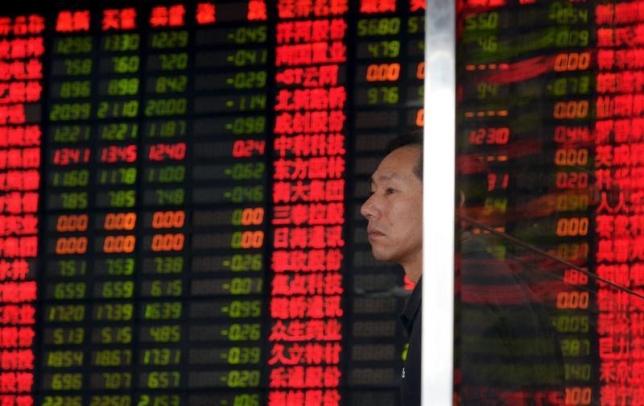 an investor stands in front of an electronic board showing stock information at a brokerage house in shanghai china september 2 2015 photo reuters