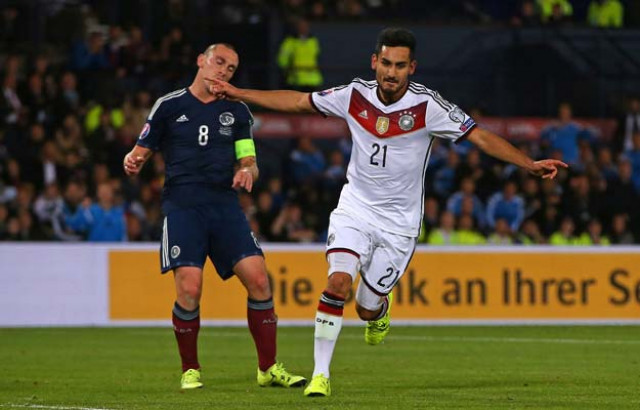 germany 039 s midfielder ilkay gundogan r celebrates after scoring their third goal as scotland 039 s midfielder scott brown reacts behind during the euro 2016 qualifying group d football match between scotland and germany at hampden park in glasgow on september 7 2015 photo afp germany 039 s midfielder ilkay gundogan r celebrates after scoring their third goal as scotland 039 s midfielder scott brown reacts behind during the euro 2016 qualifying group d football match between scotland and germany at hampden park in glasgow on september 7 2015 photo afp
