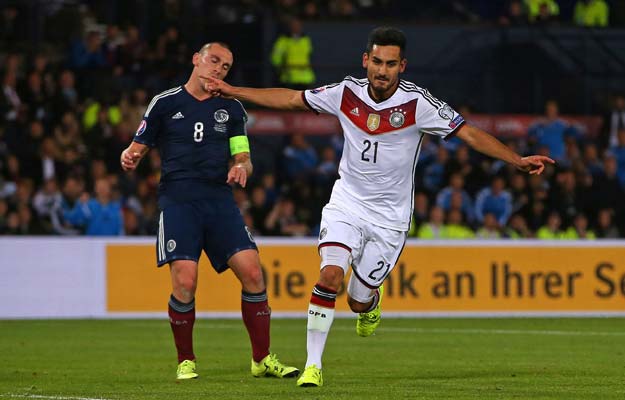 germany 039 s midfielder ilkay gundogan r celebrates after scoring their third goal as scotland 039 s midfielder scott brown reacts behind during the euro 2016 qualifying group d football match between scotland and germany at hampden park in glasgow on september 7 2015 photo afp