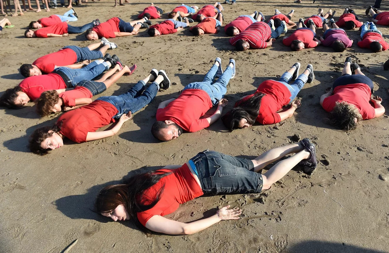 moroccans adopt the position of the lifeless body of syrian three year old aylan kurdi who drowned while fleeing the syrian war during a rally to pay tribute to the tiny boy on september 7 2015 on a beach in the capital rabat photo reuters moroccans adopt the position of the lifeless body of syrian three year old aylan kurdi who drowned while fleeing the syrian war during a rally to pay tribute to the tiny boy on september 7 2015 on a beach in the capital rabat photo reuters