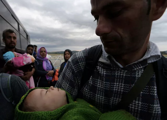 syrian refugee father tries to keep his baby son warm while waiting by a police bus to cross greece 039 s border with macedonia near the greek village of idomeni september 8 2015 photo reuters syrian refugee father tries to keep his baby son warm while waiting by a police bus to cross greece 039 s border with macedonia near the greek village of idomeni september 8 2015 photo reuters