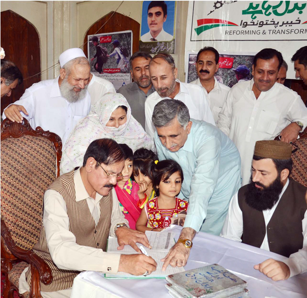 minister for information mushtaq ghani on international literacy day according to enrollment drive filling the children 039 s entry form photo online