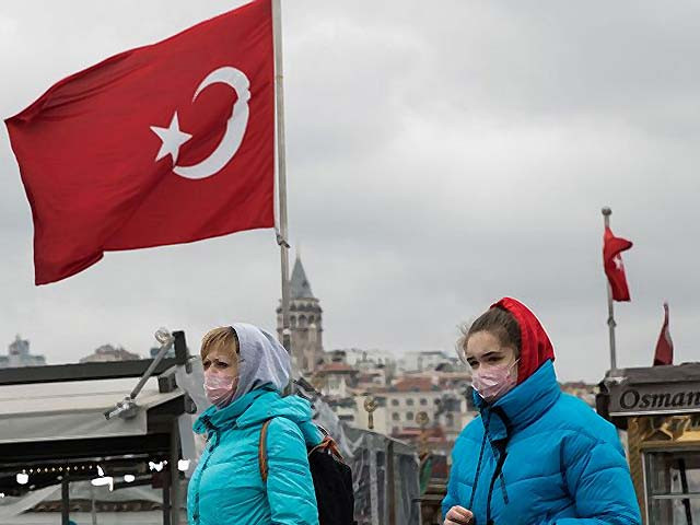 tourists wearing protective face masks walk across eminonu square in istanbul photo getty tourists wearing protective face masks walk across eminonu square in istanbul photo getty