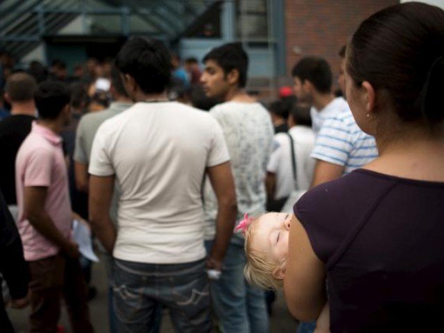 asylum seekers wait in front of the federal office for migration and refugees bamf at berlin 039 s spandau district germany august 17 2015 photo reuters