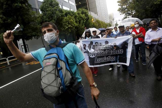 protesters holding a banner shout slogans at a rally to call for visa grants for asylum seekers in japan in central tokyo september 9 2015 photo reuters protesters holding a banner shout slogans at a rally to call for visa grants for asylum seekers in japan in central tokyo september 9 2015 photo reuters