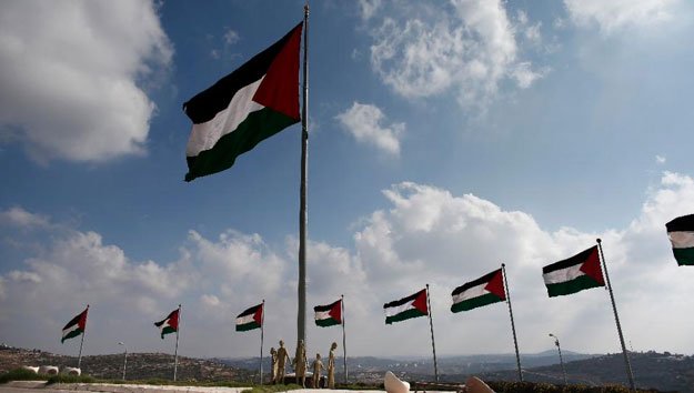palestinian flags flutter on a square in the city of rawabi just north of ramallah in the west bank on september 5 2014 photo afp