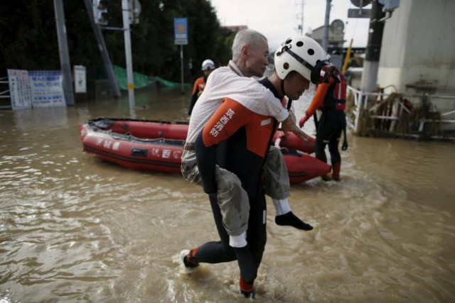 an elderly man is rescued by a firefighter at a residential area flooded by the kinugawa river caused by typhoon etau in joso ibaraki prefecture japan september 11 2015 photo reuters an elderly man is rescued by a firefighter at a residential area flooded by the kinugawa river caused by typhoon etau in joso ibaraki prefecture japan september 11 2015 photo reuters
