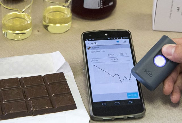a staff of the laboratory of the consumer physics society performs a test on a chocolate bar using quot scio quot a mini spectrometre which senses molecules as it scans products giving relevant information about its contents on august 03 2015 in the israeli city of hod hasharon near tel aviv photo afp a staff of the laboratory of the consumer physics society performs a test on a chocolate bar using quot scio quot a mini spectrometre which senses molecules as it scans products giving relevant information about its contents on august 03 2015 in the israeli city of hod hasharon near tel aviv photo afp