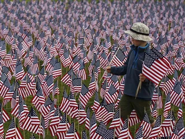 a boy walks among some of the 3 000 flags placed in memory of the lives lost in the september 11 2001 attacks at a park in winnetka illinois september 10 2015 photo reuters a boy walks among some of the 3 000 flags placed in memory of the lives lost in the september 11 2001 attacks at a park in winnetka illinois september 10 2015 photo reuters