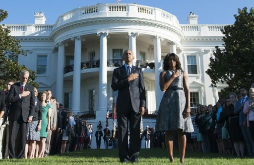 barack obama and michelle obama observe a moment of silence on the south lawn of the white house on september 11 2015 to mark the 14th anniversary of the 9 11 attacks photo afp