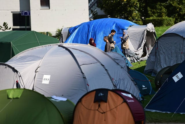 migrants wait in a makeshift tent camp in a park in brussels on september 9 2015 as they wait to have their asylum claims processed photo afp migrants wait in a makeshift tent camp in a park in brussels on september 9 2015 as they wait to have their asylum claims processed photo afp