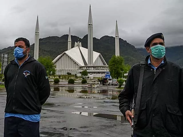 policemen wearing face masks stand guard at a checkpoint beside the grand faisal mosque during a government imposed nationwide lockdown photo getty policemen wearing face masks stand guard at a checkpoint beside the grand faisal mosque during a government imposed nationwide lockdown photo getty