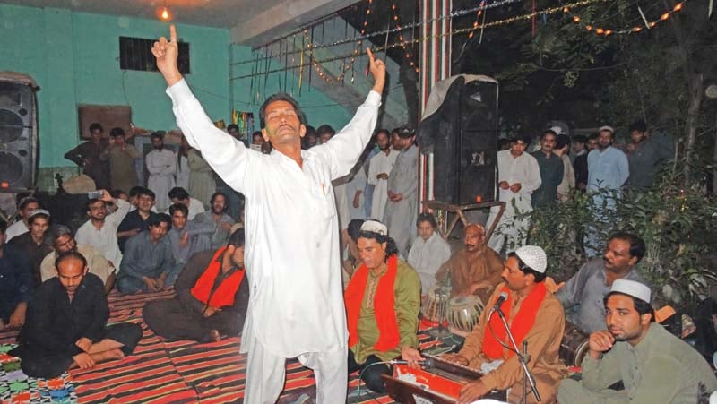 a follower sways to music playing at the urs photo zahid awan express