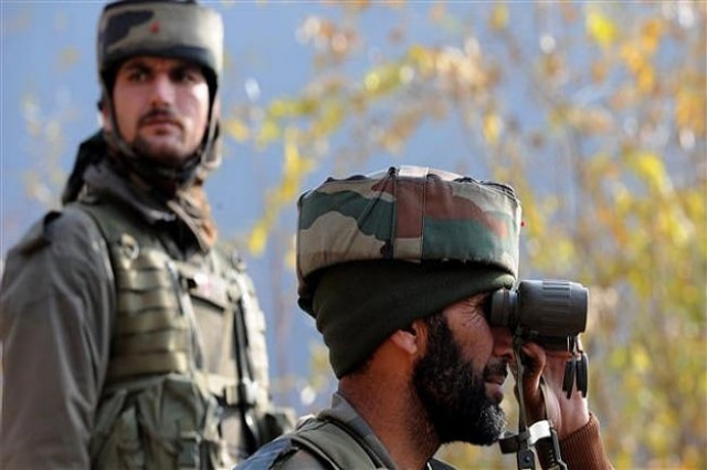 indian soldiers look on from their position by a road overlooking army barracks in gingal uri some 90 kms north of srinagar on december 5 2014 photo afp indian soldiers look on from their position by a road overlooking army barracks in gingal uri some 90 kms north of srinagar on december 5 2014 photo afp