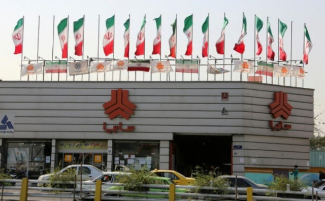 a picture taken on september 12 2015 shows cars driving past a sales office of iranian auto manufacturer saipa group in the capital tehran photo afp a picture taken on september 12 2015 shows cars driving past a sales office of iranian auto manufacturer saipa group in the capital tehran photo afp