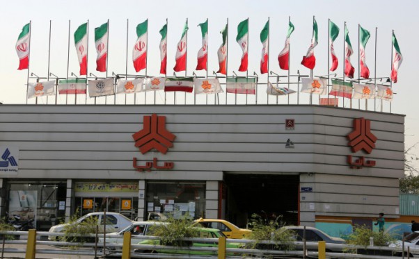 a picture taken on september 12 2015 shows cars driving past a sales office of iranian auto manufacturer saipa group in the capital tehran photo afp