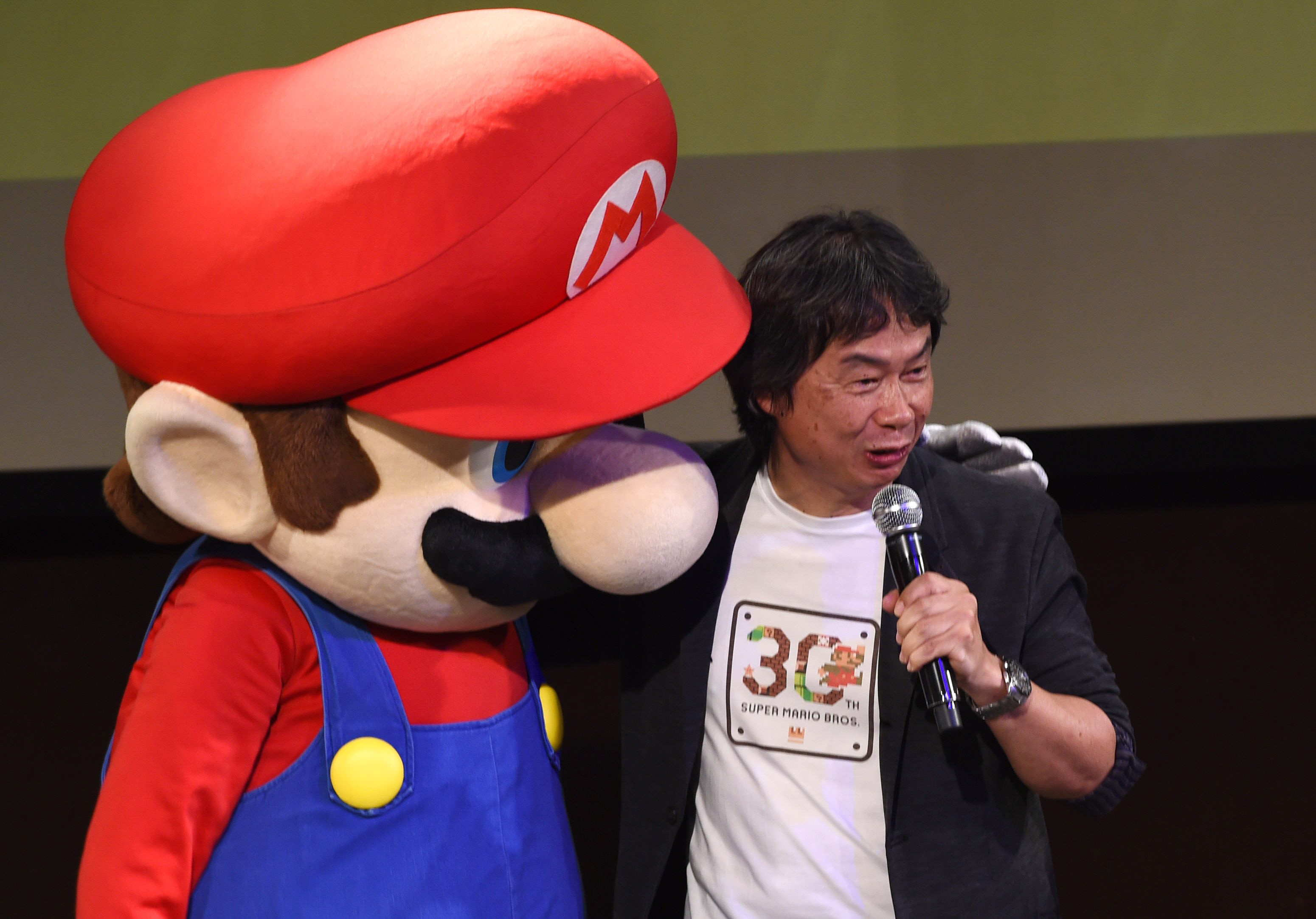 nintendo 039 s game creator shigeru miyamoto r poses with his character quot super mario quot l during a live performance of the most well known mario music to mark the game 039 s 30th anniversary in tokyo on september 13 2015 photo afp