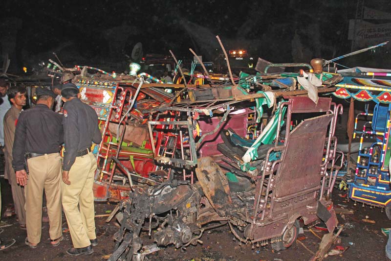 policemen inspect the site of an ied explosion in multan photo express