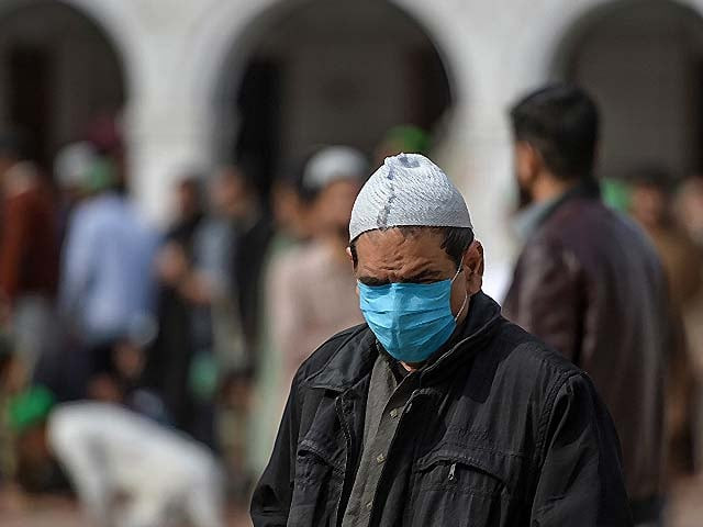 a resident wearing a facemask arrives at a mosque in rawalpindi on march 13 2020 photo afp a resident wearing a facemask arrives at a mosque in rawalpindi on march 13 2020 photo afp