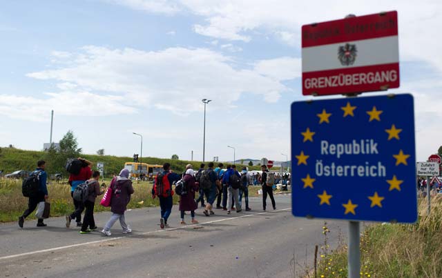 refugees cross the austrian   hungarian border near heiligenkreuz austria on september 14 2015 photo afp