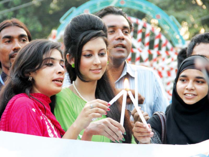 participants lit candles to mark the international day of democracy photo ayesha mir express