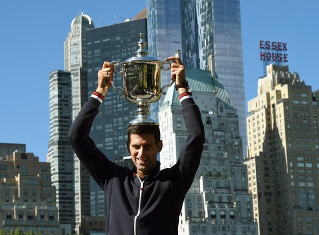 novak djokovic of serbia poses with his trophy in central park in new york september 14 2015 the morning after defeating roger federer of switzerland to win the 2015 us open men 039 s singles finals photo afp