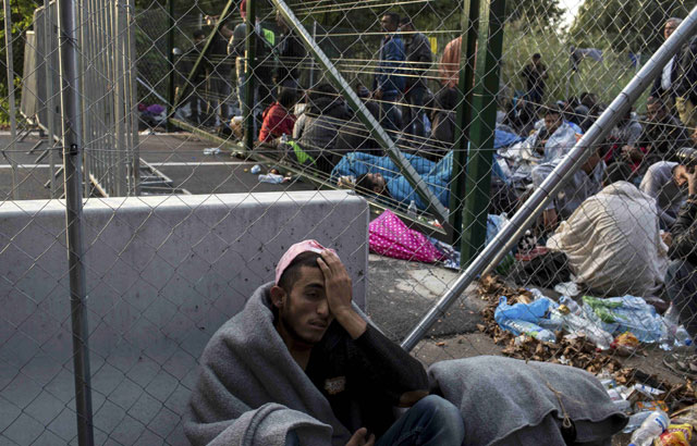 a migrant leans on a fence as he waits to enter hungary after the hungarian police sealed the border with serbia near the village of horgos serbia september 15 2015 hundreds of migrants spent the night in the open on serbia 039 s northern border with hungary their passage to western europe stalled on tuesday by a hungarian crackdown to confront the continent 039 s worst refugee crisis in two decades photo reuters