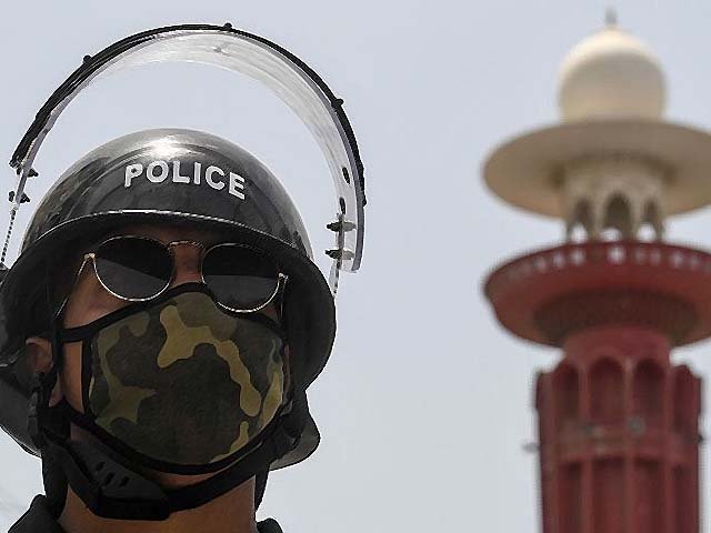 a policeman stands guard outside a closed mosque photo afp