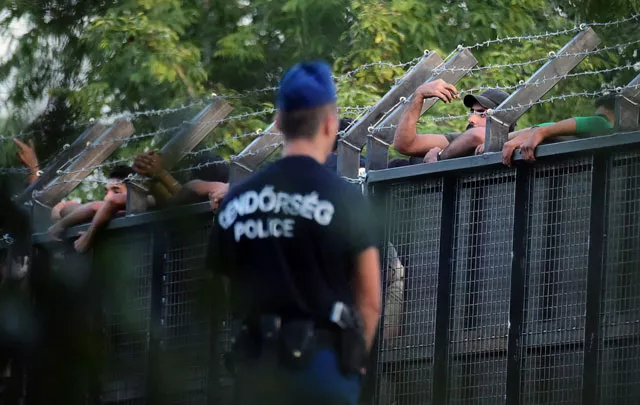 hungarian police officers stand on guard in front of a metal gate at the closed m5 highway to block circulation of migrants at the hungarian serbian border near roszke station on september 15 2015 after the hungarian government established a new border protection law photo afp hungarian police officers stand on guard in front of a metal gate at the closed m5 highway to block circulation of migrants at the hungarian serbian border near roszke station on september 15 2015 after the hungarian government established a new border protection law photo afp