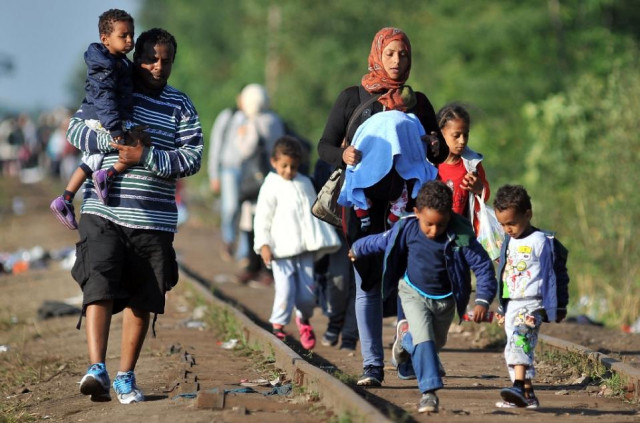 migrants walk down railway tracks to the hungarian border near the northern serbian town of horgos on september 14 2015 photo afp migrants walk down railway tracks to the hungarian border near the northern serbian town of horgos on september 14 2015 photo afp
