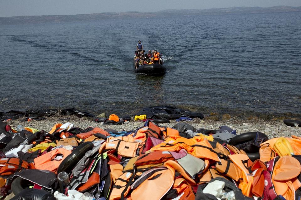 migrants arrive on the shores of the greek island of lesbos after crossing the aegean sea from turkey on a dinghy on september 10 2015 photo afp