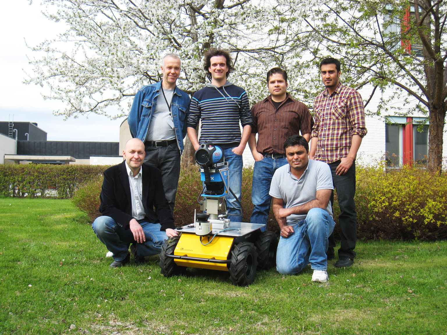 asif arain with his group and the robot in sweden photo asif arain