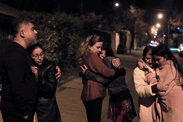 people remain in the street during a strong quake in santiago on september 16 2015 a strong 7 2 magnitude earthquake struck the center of chile on wednesday local seismologists said triggering a tsunami alert sparking panic and shaking buildings photo afp