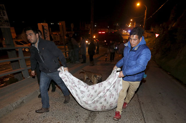 people recover items from their destroyed shop caused by waves in concon city september 16 2015 after a mass evacuation of the entire coastline during a tsunami alert after a magnitude 8 3 earthquake hit off the coast of chile on wednesday photo reuters