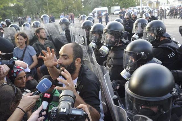 a migrant talks to the media in front of hungarian riot police at the border crossing with serbia in roszke hungary september 16 2015 hungarian police fired tear gas and water cannon at protesting migrants demanding they be allowed to enter from serbia on wednesday on the second day of a border crackdown photo reuters a migrant talks to the media in front of hungarian riot police at the border crossing with serbia in roszke hungary september 16 2015 hungarian police fired tear gas and water cannon at protesting migrants demanding they be allowed to enter from serbia on wednesday on the second day of a border crackdown photo reuters
