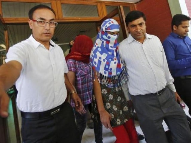 two veiled nepali women who told police they were raped by a saudi official walk outside nepal 039 s embassy in new delhi india september 9 2015 photo reuters