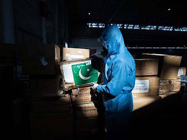 a staff member carrying a box of medical supplies from pakistan at a warehouse in wuhan photo afp a staff member carrying a box of medical supplies from pakistan at a warehouse in wuhan photo afp