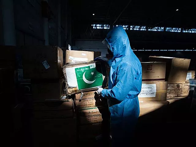 a staff member carrying a box of medical supplies from pakistan at a warehouse in wuhan photo afp a staff member carrying a box of medical supplies from pakistan at a warehouse in wuhan photo afp