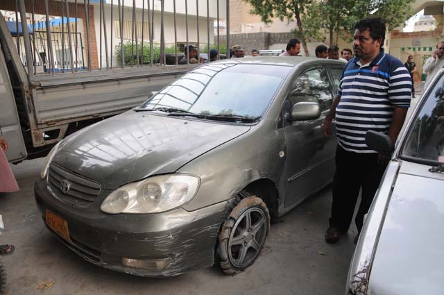 mqm mpa saifuddin khalid standing next to his car that came under fire on friday photo mohammad noman express