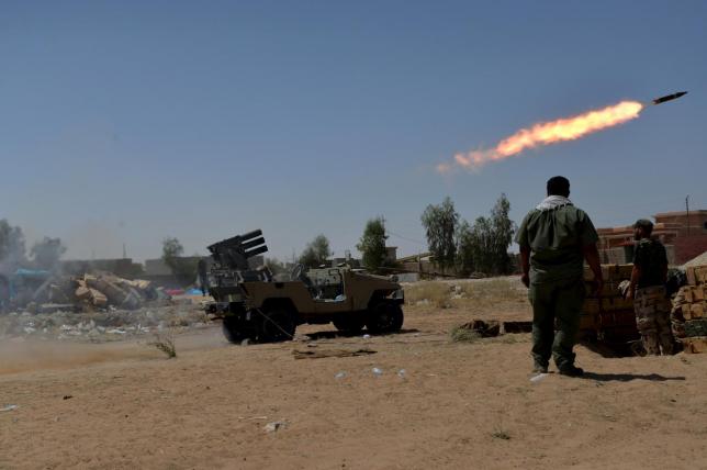 shia fighters launch a rocket towards islamic state militants on the outskirt of bayji on june 11 2015 photo reuters