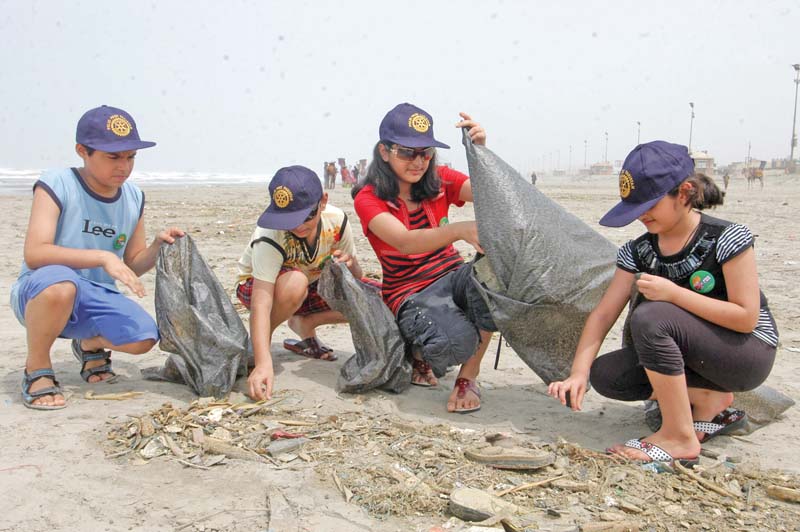 volunteers clean up the clifton beach by picking up garbage littered all over the place around 50 5 per cent of this waste is plastic material which is harmful to marine life photo file