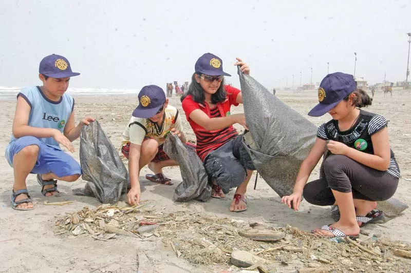 volunteers clean up the clifton beach by picking up garbage littered all over the place around 50 5 per cent of this waste is plastic material which is harmful to marine life photo file volunteers clean up the clifton beach by picking up garbage littered all over the place around 50 5 per cent of this waste is plastic material which is harmful to marine life photo file