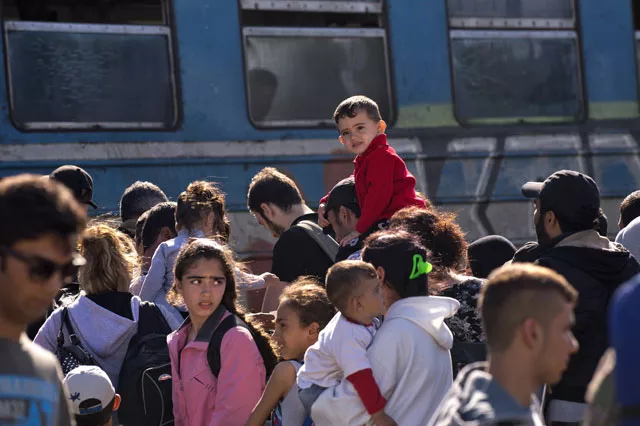 migrants and refugees queue to board a train heading to serbia near the town of gevgelija on the border between greece and macedonia on september 21 2015 eastern european ministers are due to gather to once again voice their opposition to compulsory migrant quotas as countries creaking under the strain of a steady stream of refugees struggle to agree on common action photo afp migrants and refugees queue to board a train heading to serbia near the town of gevgelija on the border between greece and macedonia on september 21 2015 eastern european ministers are due to gather to once again voice their opposition to compulsory migrant quotas as countries creaking under the strain of a steady stream of refugees struggle to agree on common action photo afp