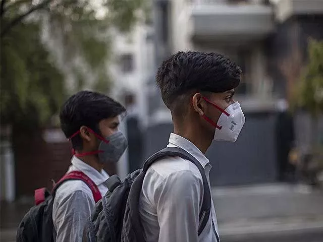boys wear protective masks as they walk back to their homes after school photo afp boys wear protective masks as they walk back to their homes after school photo afp