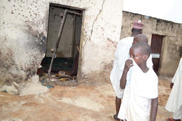 a child covers his nose inside a mosque where a suicide bomber killed over 20 worshippers in maiduguri on monday photo afp