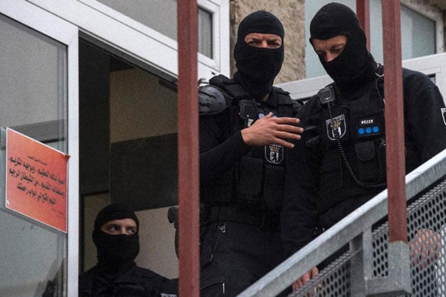 german police stand outside an association linked to a mosque in berlin 039 s central tempelhof schoeneberg district during raid targeting individuals suspected of inciting people to fight for the islamic state group in syria on september 22 2015 photo afp german police stand outside an association linked to a mosque in berlin 039 s central tempelhof schoeneberg district during raid targeting individuals suspected of inciting people to fight for the islamic state group in syria on september 22 2015 photo afp