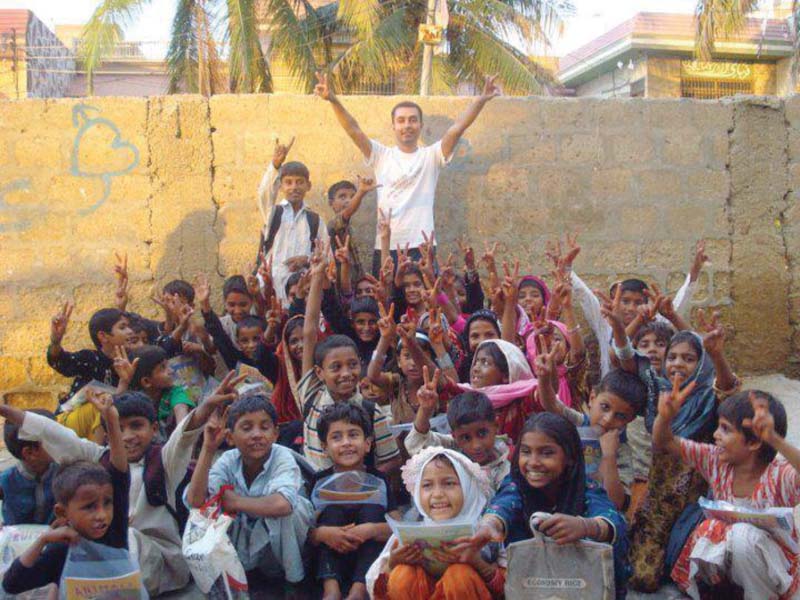 syed fahad ali poses with his students he runs the aghaaz school entirely on his own in gulshan e iqbal which has 60 per cent girls in a total enrolment of 124 students photo courtesy syed fahad ali