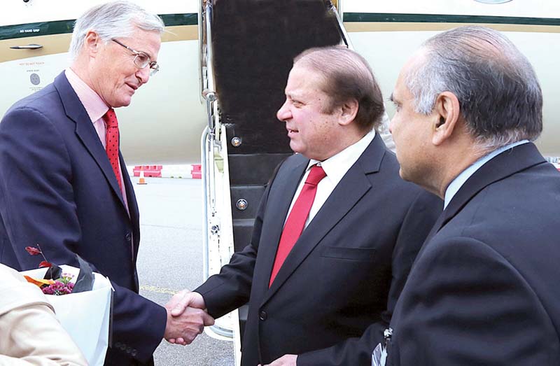 british official david pearey receives pm nawaz at an airport in london photo app