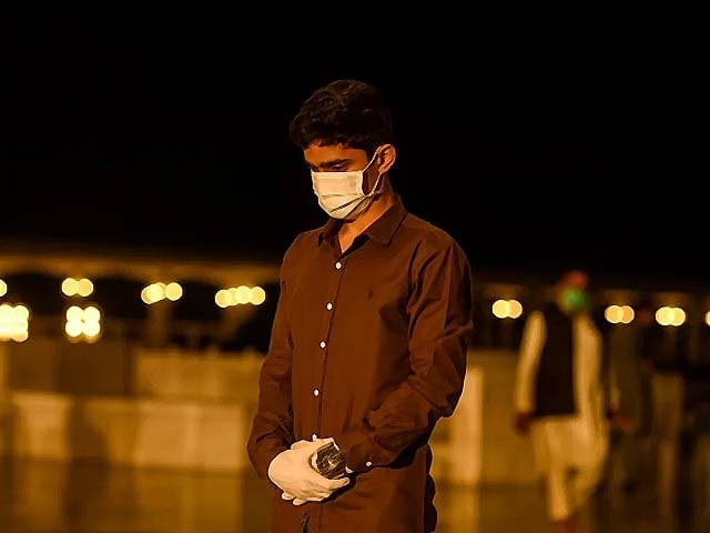 a muslim wearing a face mask and gloves offers taraweeh prayers photo afp a muslim wearing a face mask and gloves offers taraweeh prayers photo afp